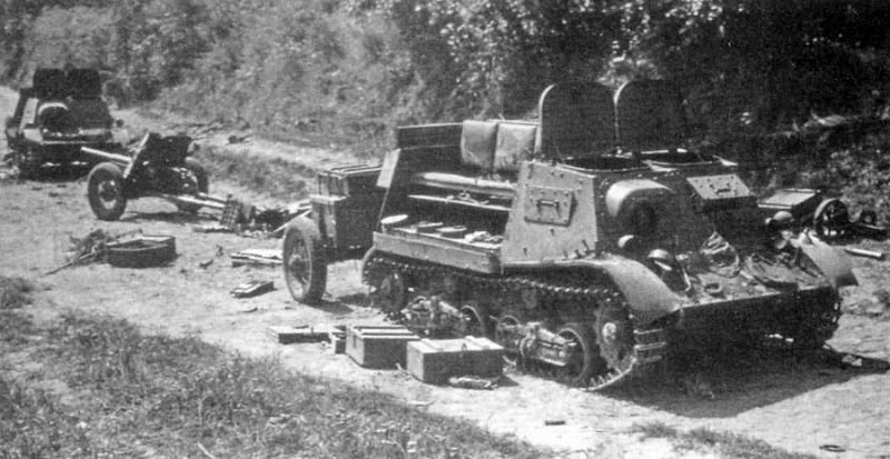 A pair of abandoned Komsomolets with their loads strewn across the road